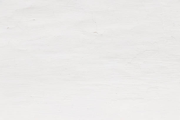 istock Rock plastered stucco wall. Stucco wall, white texture, white background, wall background. Blank concrete wall white color. A part of a white wall. 1255460530