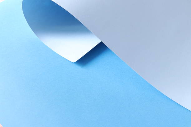 istock Paper, rolled-up, blue, background. Beautiful light blue background with lights and shadows. Background with rolled-up paper. Shadow, light, geometric. Trend background. 1255460534