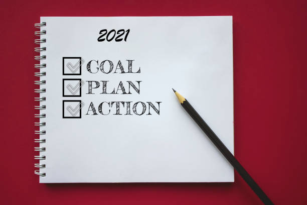 istock School notebook with text Goal, plan and action for 2021 and pencil on red background, back to school concept, modern elementary education. flat lay. 1255461483
