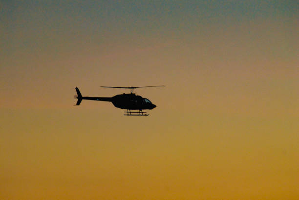 istock Twilight Helicopter silhouette in midair 1255461655