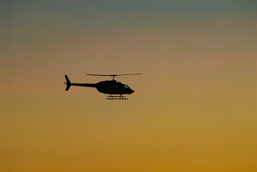 Twilight Helicopter silhouette in midair