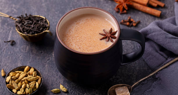 istock Indian masala tea with milk and spices in mug. Grey background. Close up. 1255461991