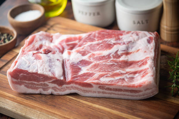 istock fresh pork belly block on wooden board 1255462919