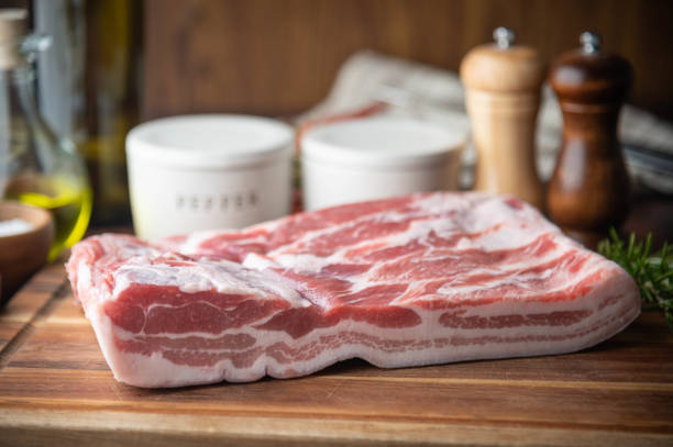 istock fresh pork belly block on wooden board 1255462925