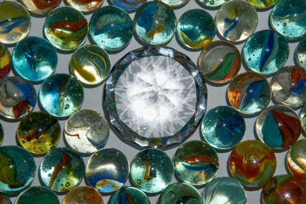 istock Yellow, green, blue and red glass marbles on a table. 1255463223