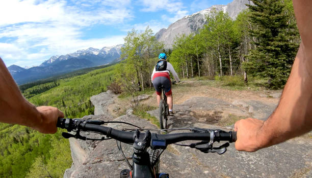 istock Couple on mountain e-bikes ride along mountain ridge 1255466414