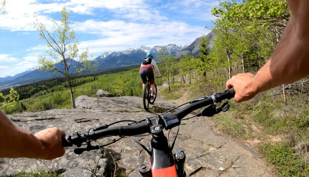 istock Couple on mountain e-bikes ride along mountain ridge 1255467645