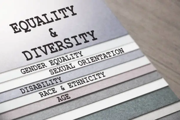 Photo of Equality and Diversity gender sexual orientation ethnicity disability age words on pages of copybook . Social concept