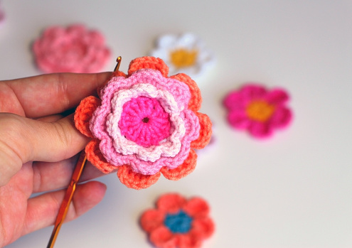 This colored floral motif is crocheted of pink and orange flowers.