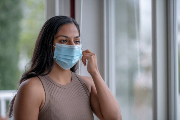 istock Hispanic woman wearing face mask 1255478048