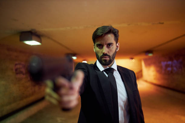istock Special secret agent aiming with a handgun on a subway station 1255479839
