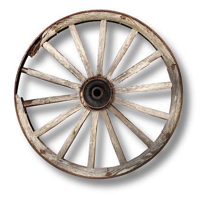 worn wooden vintage wagon wheel casting shadow on white background