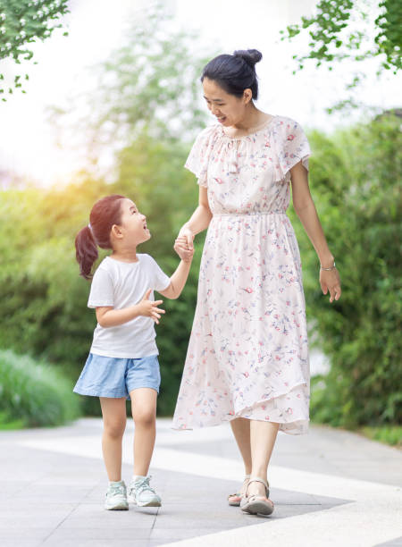 istock Mom and daughter walking and talking 1255481950