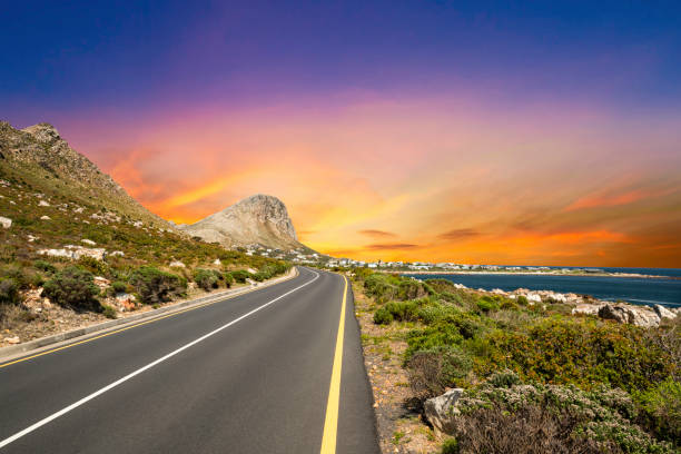 Winding beach side road in Betty's Bay Cape Town Winding beach side road in Betty's Bay Cape Town hermanus stock pictures, royalty-free photos & images