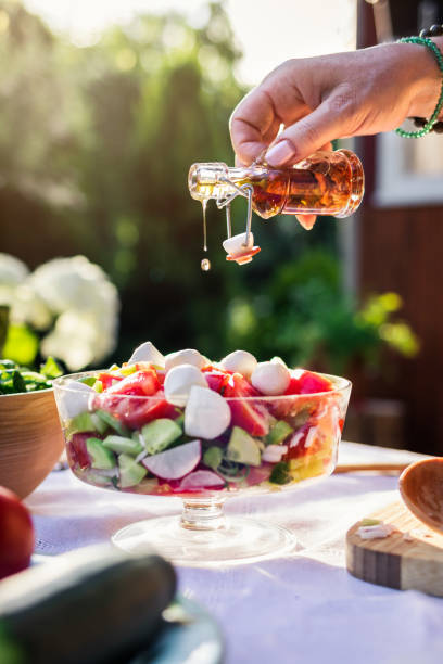 istock Pouring olive oil to vegetable salad 1255483307