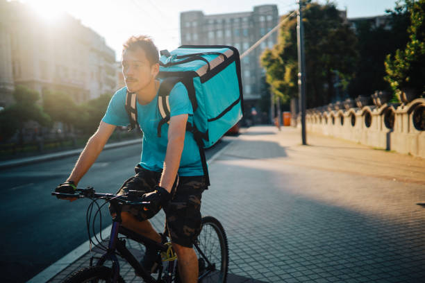 istock Food delivery man on the bicycle 1255486016