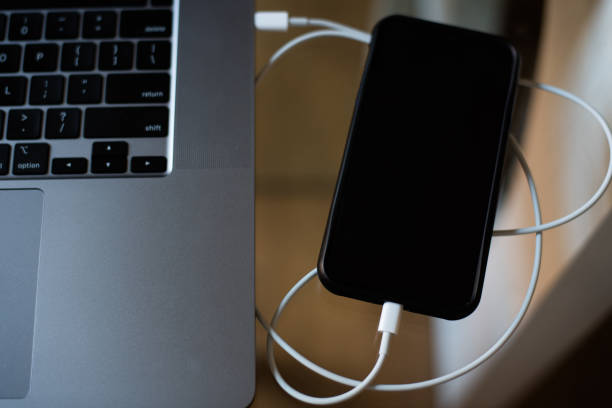 istock Laptop charge cell phone 1255487651