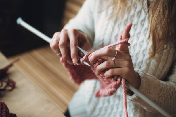 istock Close up on woman's hands knitting 1255490647