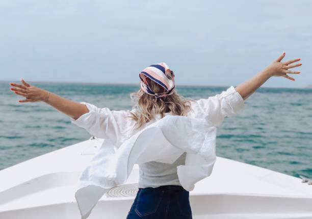 Women in a boat with open arms - fotografia de stock