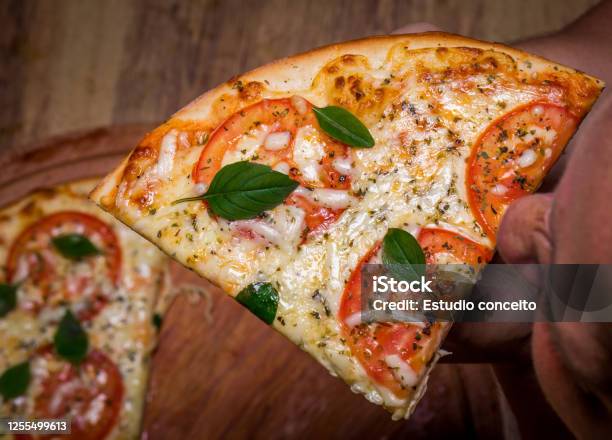 Eating Slice Of Pizza Margherita Close Up Stock Photo - Download Image Now - Pizza, Brazil, Eating