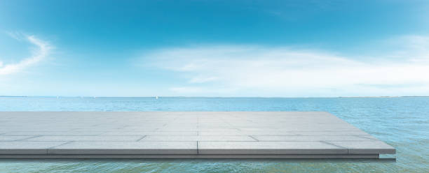 istock Empty square floor and lake water under blue sky. 1255502118