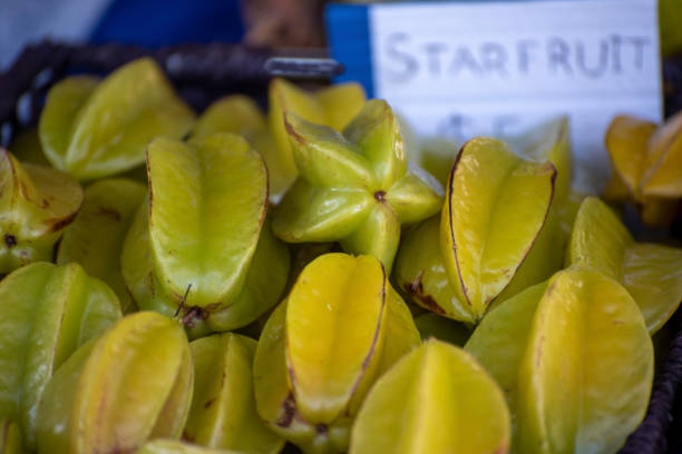 Star fruit at an outdoor produce market in Bellingen, NSW. Star fruit at an outdoor produce market in Bellingen, NSW. starfruit stock pictures, royalty-free photos & images