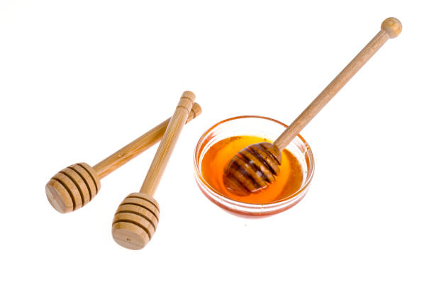 istock Wooden spoons for honey isolated on white background. 1255503675
