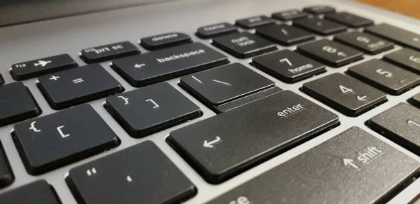 istock Keyboard of laptop highlighting enter button 1255504329