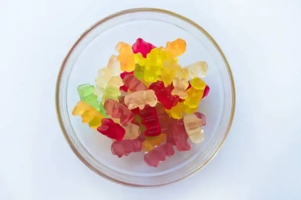 Plate with jelly  bears on a white background. Flat lay.