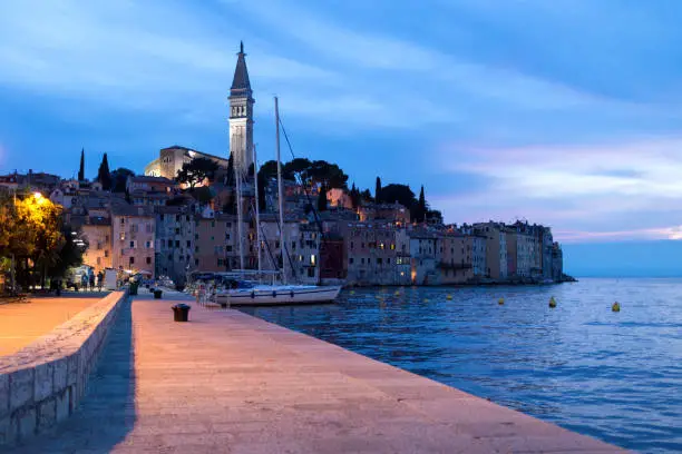 Rovinj embankment in the evening, streetlights, yachts in the harbor. Tourism