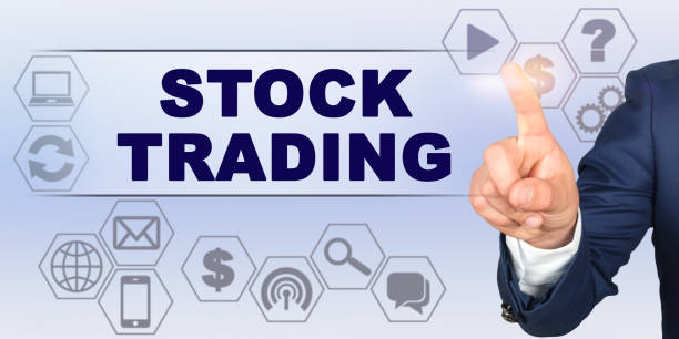 istock Businessman touching virtual screen with his finger. Screen caption - STOCK TRADING 1255522290