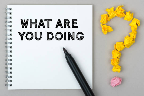 istock Hand with marker writing: What Are you Doing. 1255522294