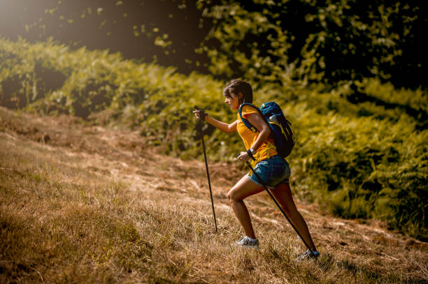 istock Young women climbing up the hill 1255525741