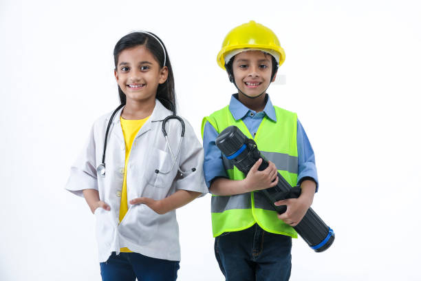 coltivare i loro interessi- bambino vestito da medico e ingegnere edile - indian costume foto e immagini stock