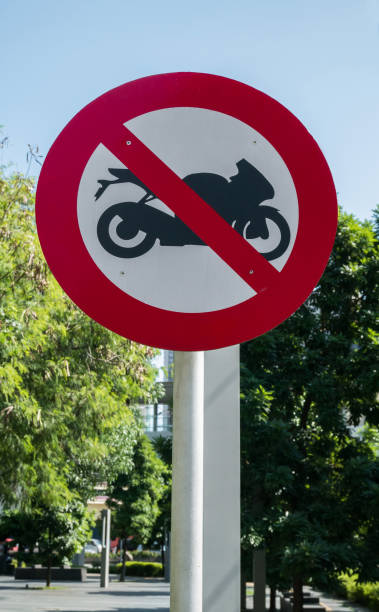 istock Motorcycle prohibition sign at pole in public park. 1255526498