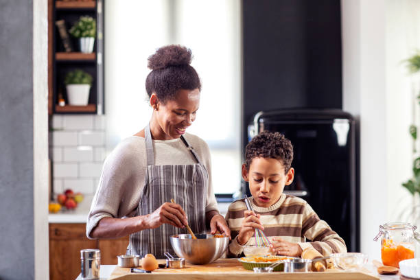 istock Woman prepare pie in the kitchen and learn his son cooking 1255526556