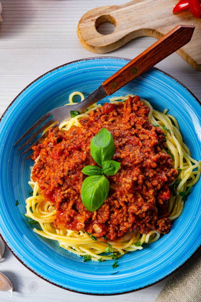 istock Delicious spaghetti bolognese on white background 1255529448