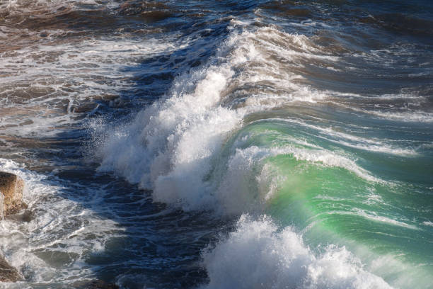 istock Ocean wave background breaking sea water rocky shore 1255537939