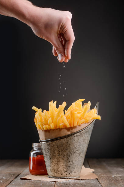istock Hand sprinkles pinch of salt 1255538016
