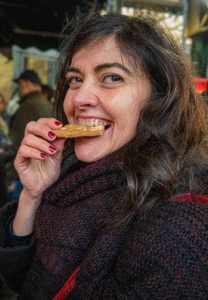 istock Pretty mature girl eating a cookie 1255541357