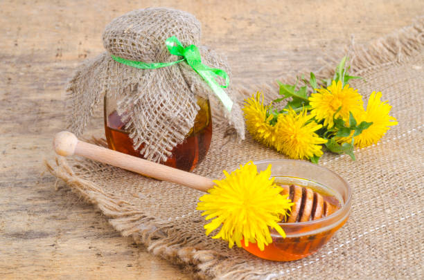 istock Transparent sweet flower honey from spring dandelions. 1255541606
