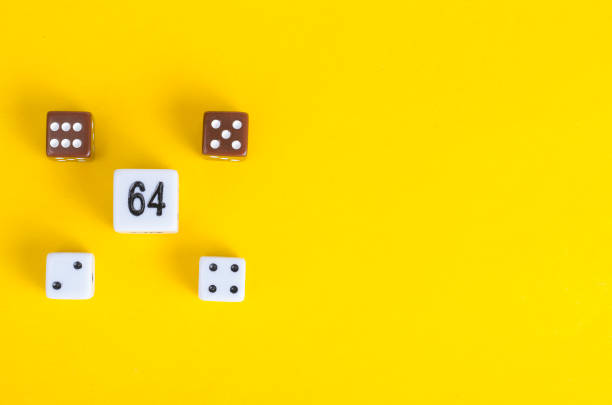 istock Simple game cubes, dice on bright yellow background. Casino gambling concept 1255542226