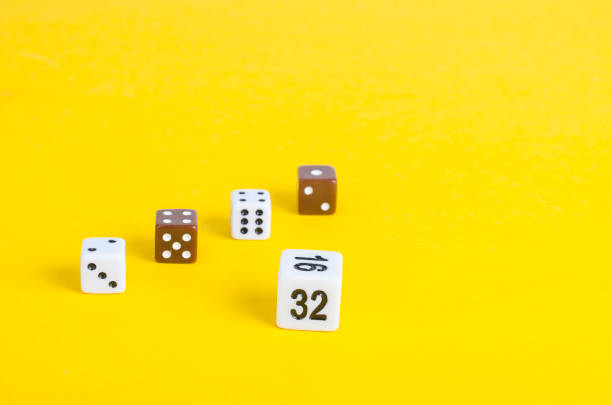 istock Simple game cubes, dice on bright yellow background. Casino gambling concept 1255542227