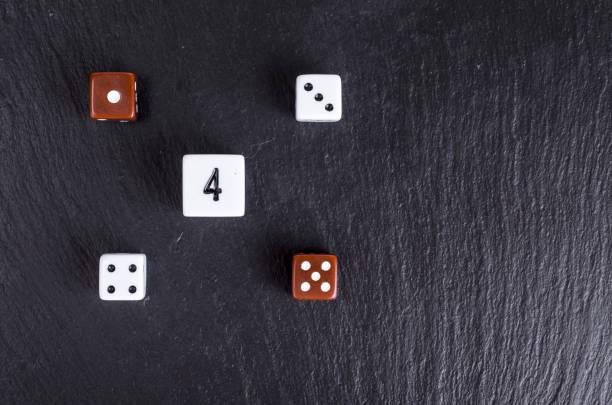 istock Rolling dices with any number over black background. Casino gambling concept. 1255542232