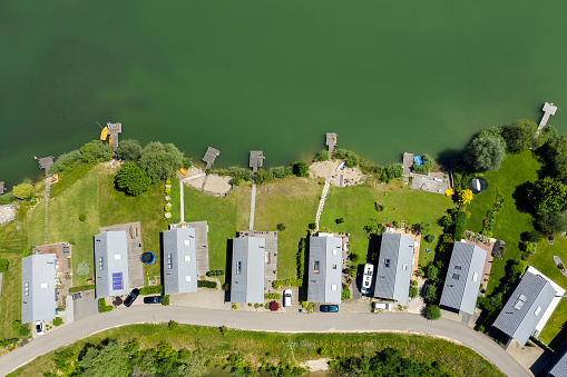 Rows of holiday homes on the lake, aerial view.