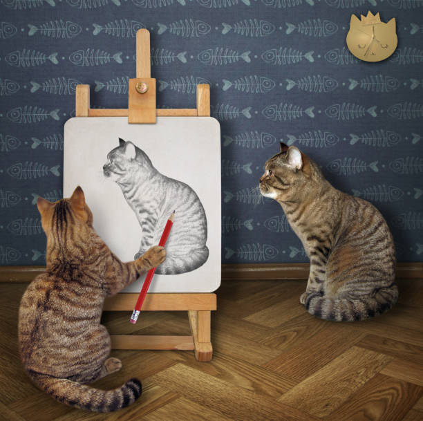 istock Cat artist drawing his friend 1255544136