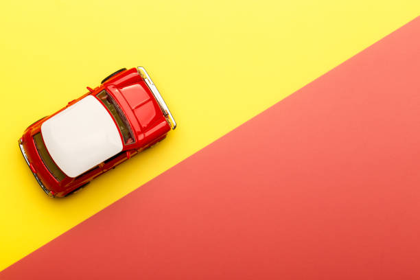 istock Red small toy car on vibrant background 1255545697