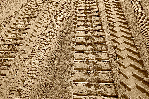 tire tracks prints in sand on a beach