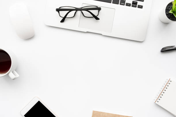 istock White office desk table with laptop computer, smartphone and office supplies. Top view with copy space, flat lay. 1255546492