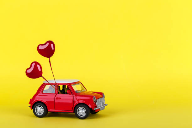 istock Red small toy car on vibrant background 1255546571